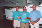 (L-R) Richard Denning, Capt. Jerry and Bob Black with their trophy and prize boat after winning the 2001 SKA National Championship.