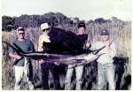 Buddy Grooms (second from right) with friends and his NC State Record 100 pound sailfish.